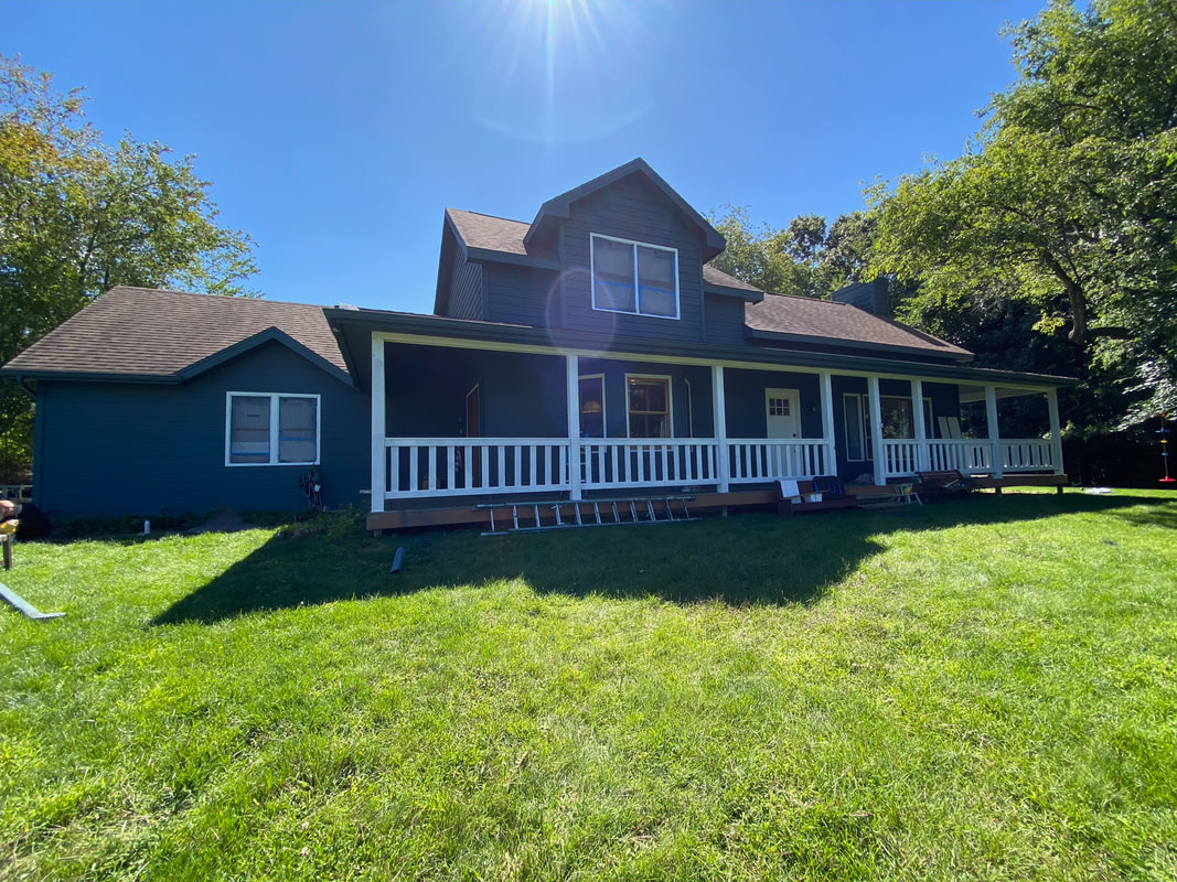 Finished navy ranch exterior with white porch — Greater Lansing job by MDH Painting
